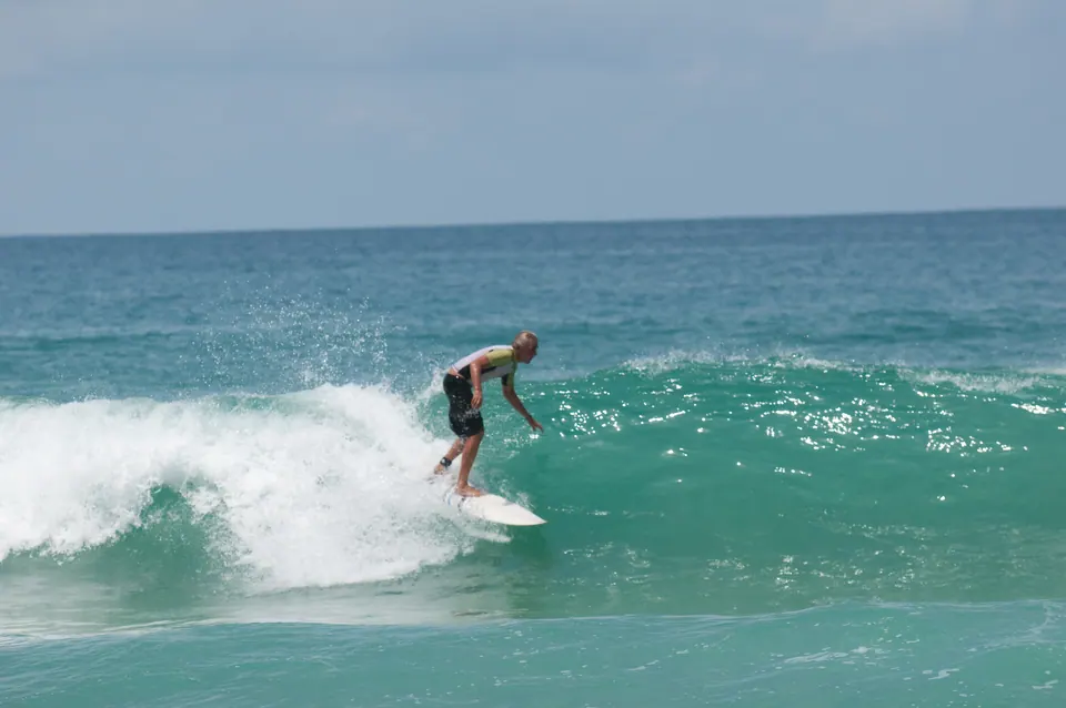 Surfer at Surin Beach, Phuket; destination view, not a hotel photograph